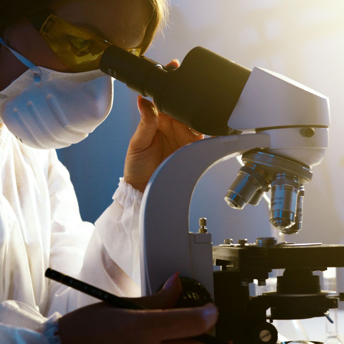 Scientist using microscope in laboratory, representing health sector advisory